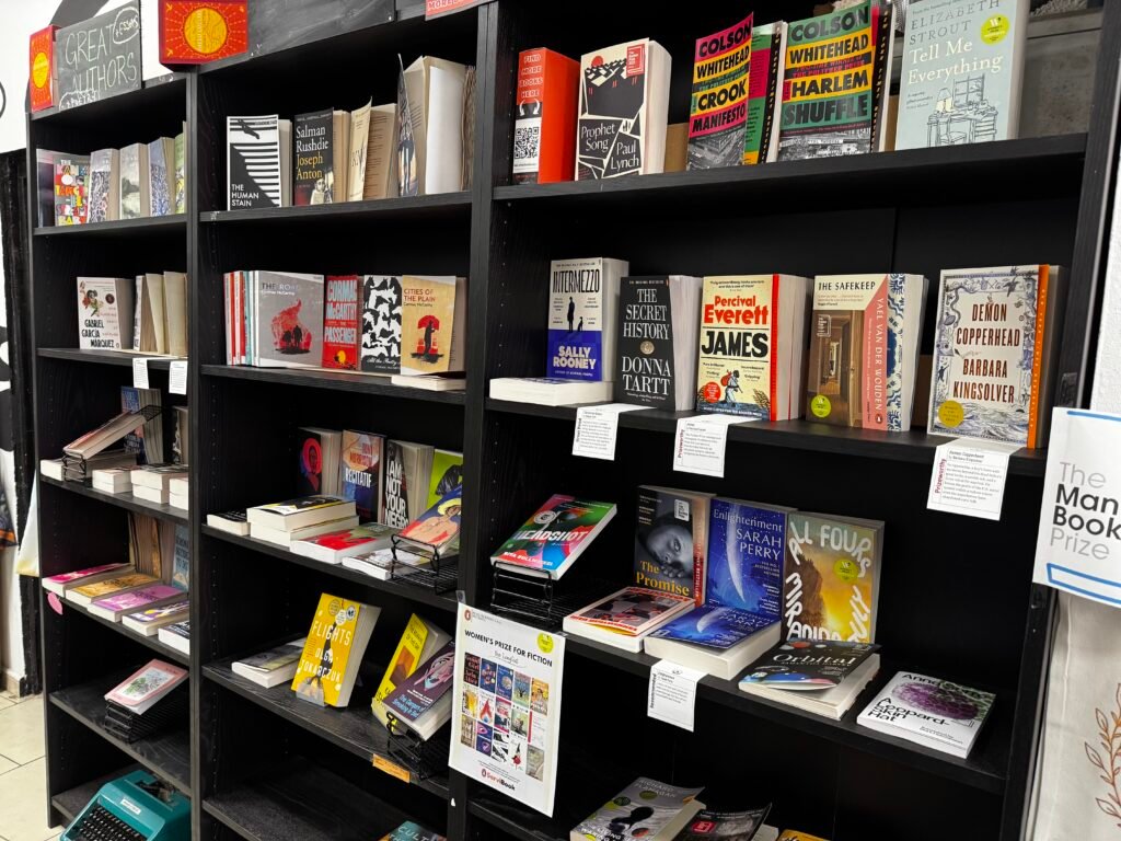 Interior bookshelves displaying a variety of English-language books at Book Lovers Valencia in Valencia, Spain.